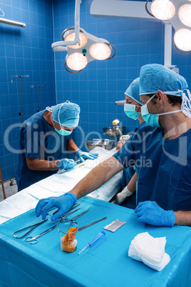 Surgery team operating a patient in an operating room