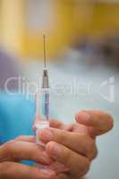 Close-up of female doctor holding an injection