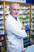 Pharmacist standing with arms crossed