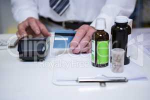 Pharmacist using payment terminal machine