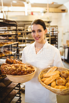 Female baker holding basket of sweet foods