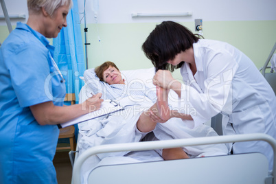 Doctor giving foot treatment to patient