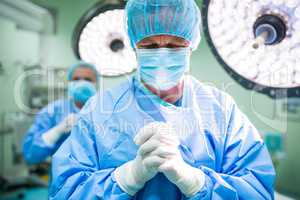 Surgeon praying in operation room while operation