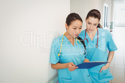 Nurses looking at clipboard