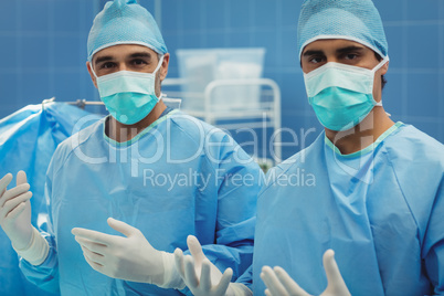 Portrait of male surgeons preparing for operation in operation r