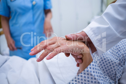 Doctor examining patients pulse