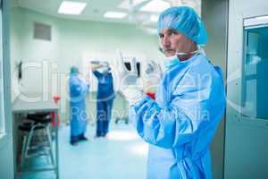 Portrait of surgeon looking at camera in operation room