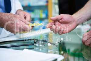 Pharmacist giving medicine to customer