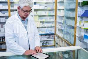 Pharmacist using a digital tablet