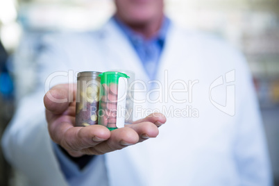 Pharmacist holding a bottle of drug