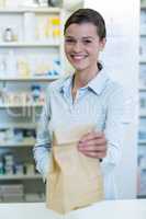 Pharmacist holding a medicine package in pharmacy