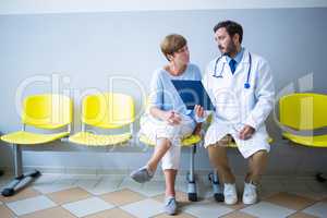 Doctor and patient discussing over report