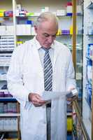 Pharmacist holding a prescription and medicine