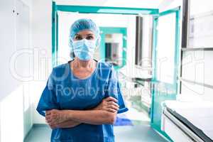 Surgeon standing in corridor at hospital