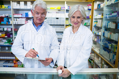 Pharmacists checking and writing prescription for medicine