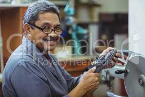 Portrait of shoemaker using sewing machine