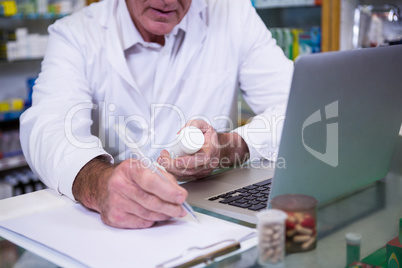 Pharmacist writing prescriptions for medicines