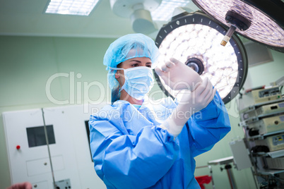Female surgeon wearing surgical gloves