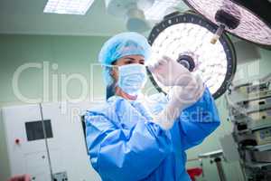 Female surgeon wearing surgical gloves