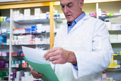 Pharmacist reading prescriptions