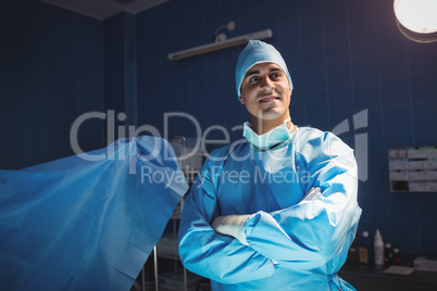 Surgeon standing with arms crossed in operation room