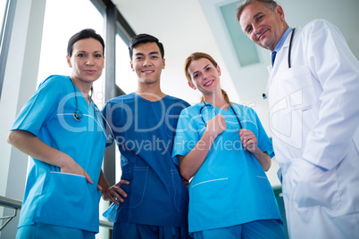Portrait of doctor and surgeons standing together in corridor