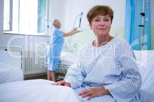 Portrait of smiling patient sitting on bed