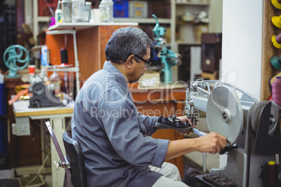 Shoemaker using sewing machine