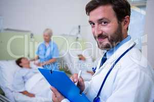 Portrait of smiling doctor checking a medical report
