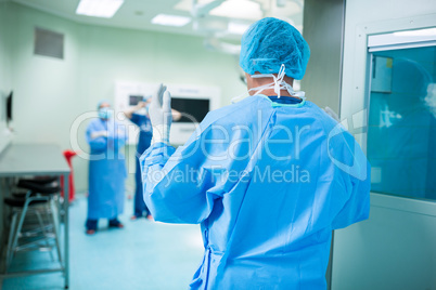 Rear view of surgeon walking in operation room