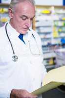 Pharmacist reading prescriptions