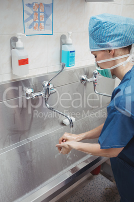 Female surgeon washing her hands