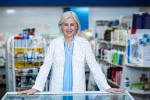 Pharmacist standing at counter in pharmacy