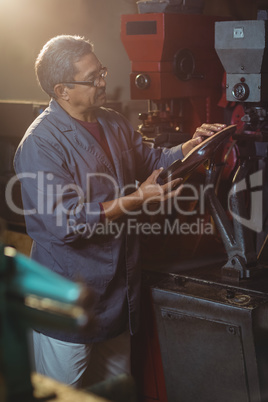 Shoemaker examining a shoe