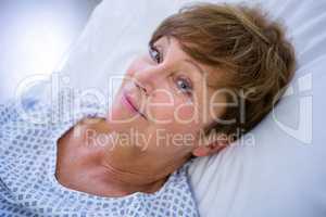 Portrait of smiling patient lying on bed