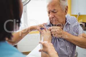 Female doctor giving an injection to a patient