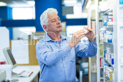 Pharmacist checking a box of medicine