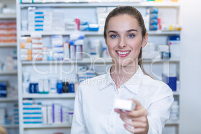 Pharmacist showing a medicine in pharmacy