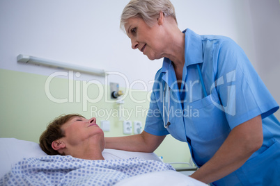 Nurse checking patient temperature