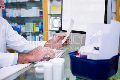 Pharmacist making entries on computer