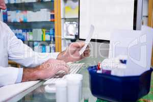 Pharmacist making entries on computer