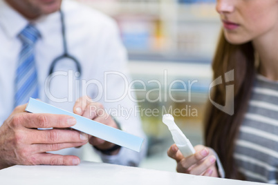 Customer and pharmacist reading pregnancy test