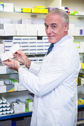 Pharmacist checking boxes of medicine