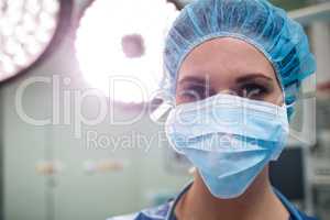 Portrait of surgeon wearing surgical mask in operation room