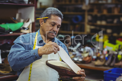 Shoemaker repairing a shoe