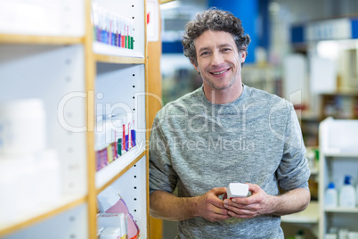 Customer holding a bottle of drug in pharmacy