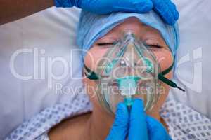 Nurse placing an oxygen mask on the face of a patient