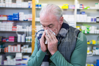 Customer covering his nose with handkerchief while sneezing