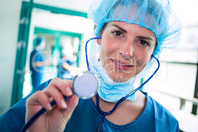 Portrait of smiling female surgeon holding stethoscope