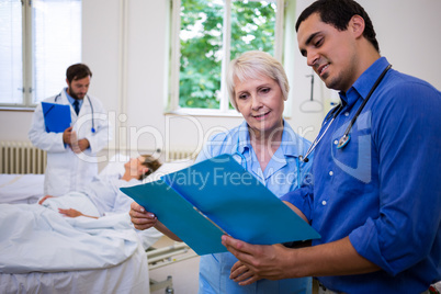 Doctor and nurse checking a medical report